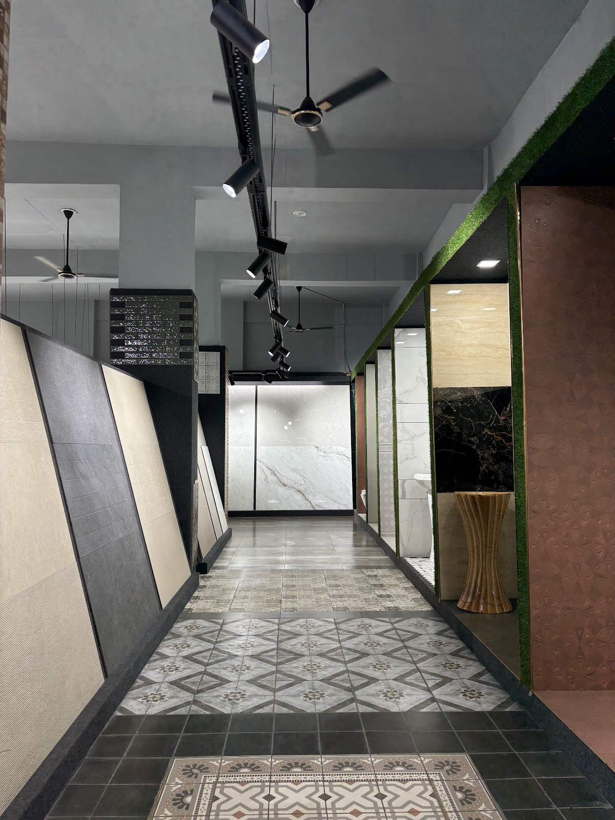 Long showroom aisle with large format and decorative tile installations at World of Tile Noida