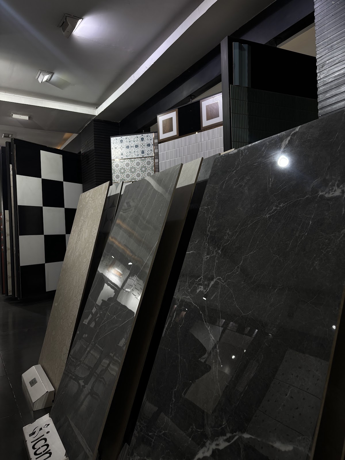 Upright dark marble finish tile displays at the World of Tile showroom in Sector 9 Noida