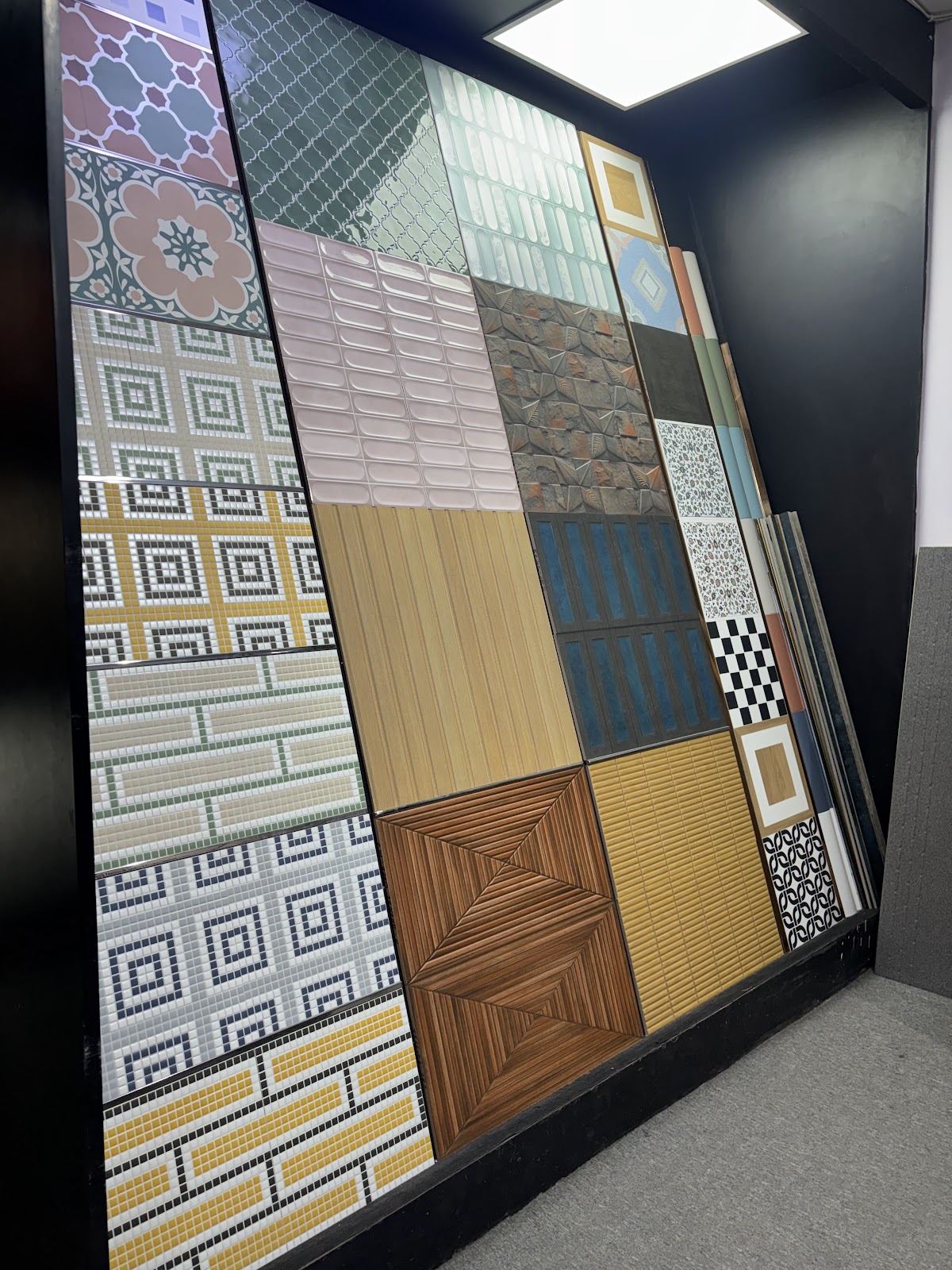 Tall showroom display of patterned and textured surface options at World of Tile Noida