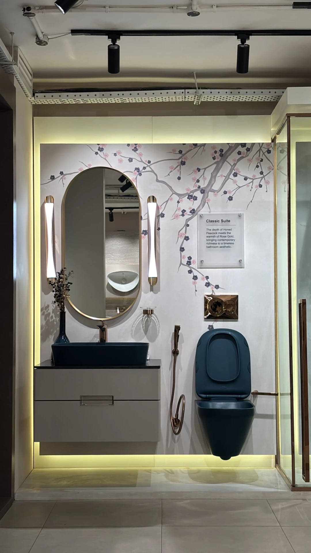 Classic Suite bathroom display at World of Tile Noida with peacock blue fixtures, rose gold accents and large format wall tiles