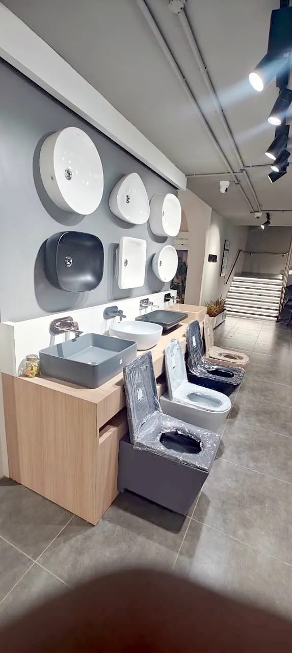 Counter top basins on a wooden vanity in the showroom