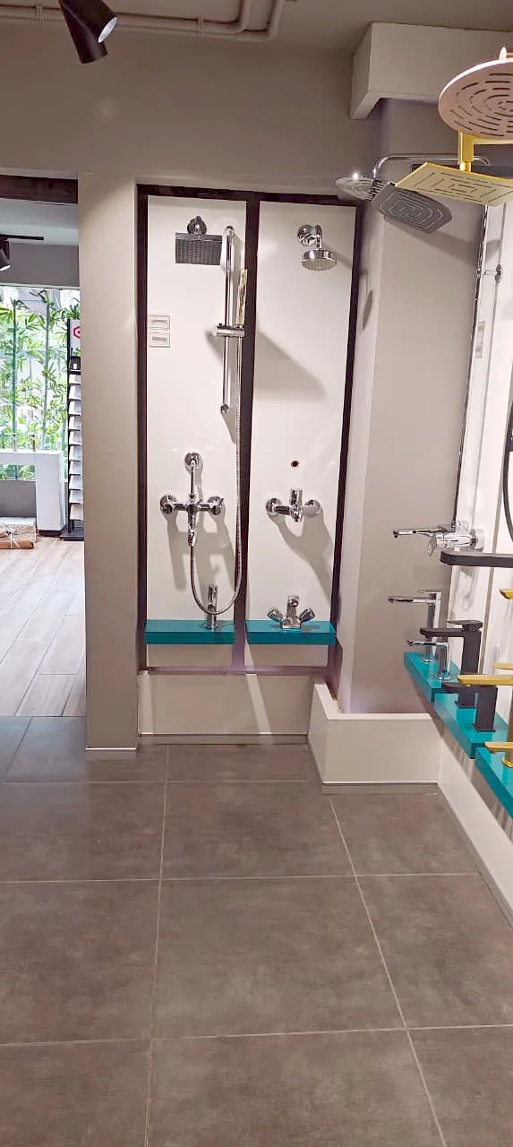 Shower enclosure set beside a daylit window in the showroom