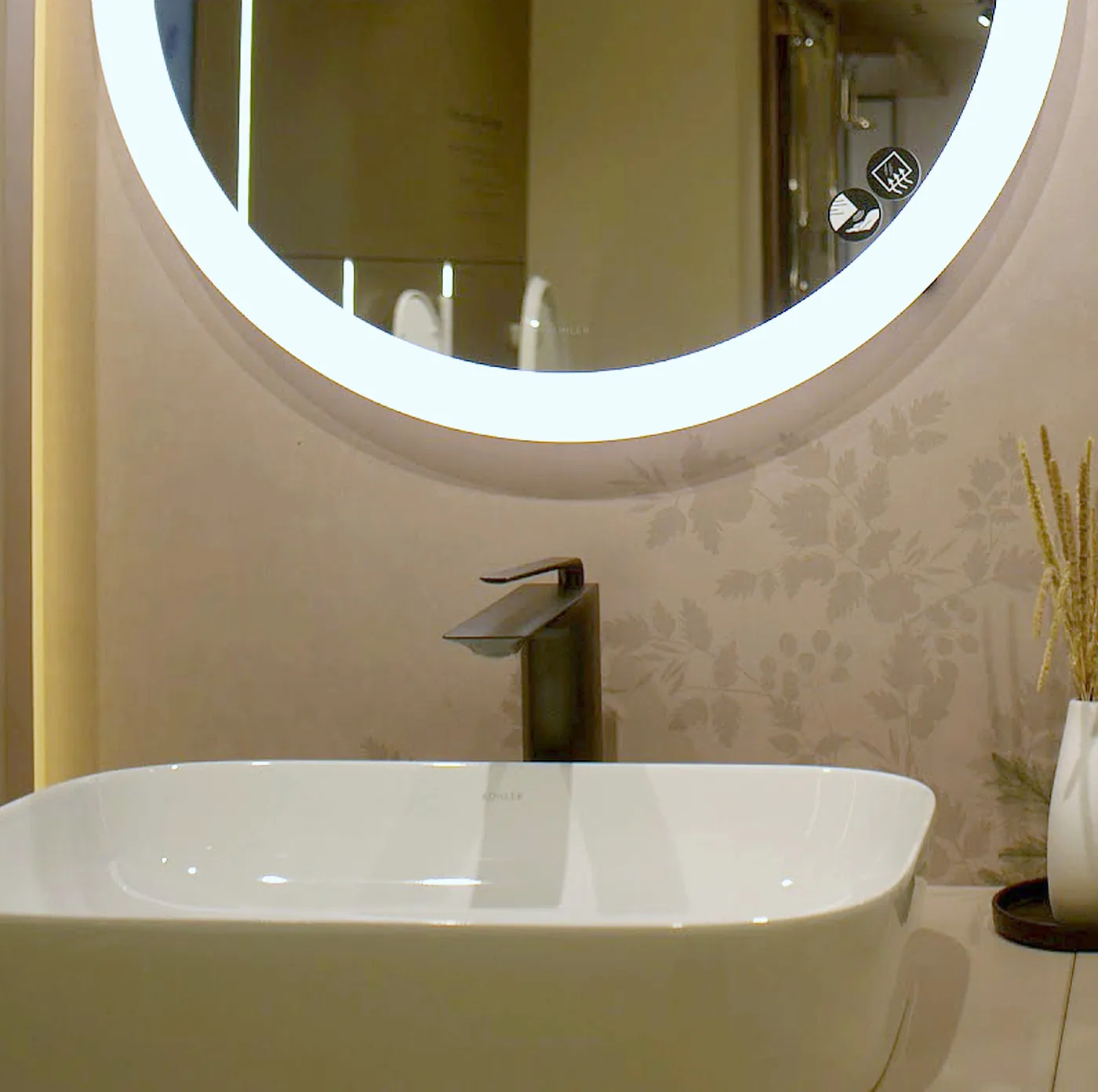 Matte black tall basin faucet above a white Kohler vessel basin in the Noida showroom