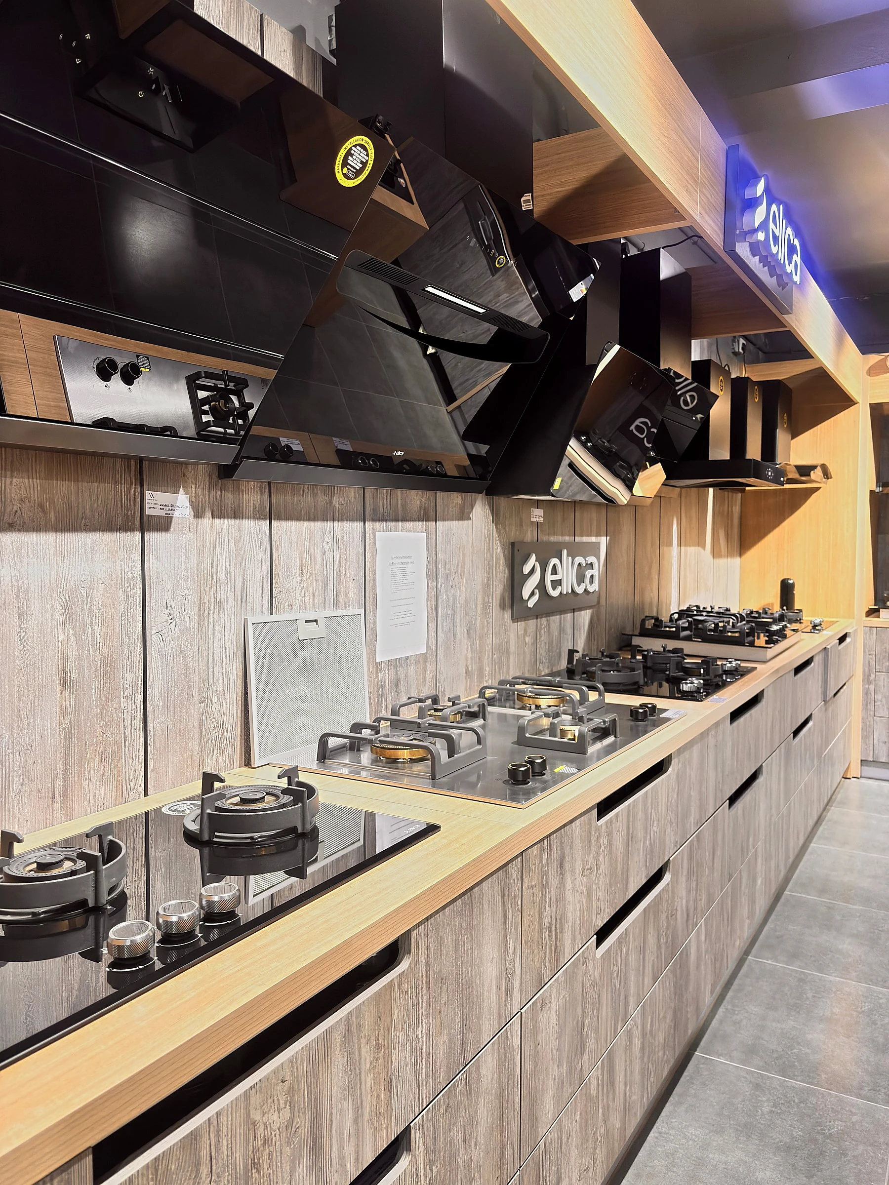 Elica chimneys and built-in hobs displayed in a kitchen run at World of Tile