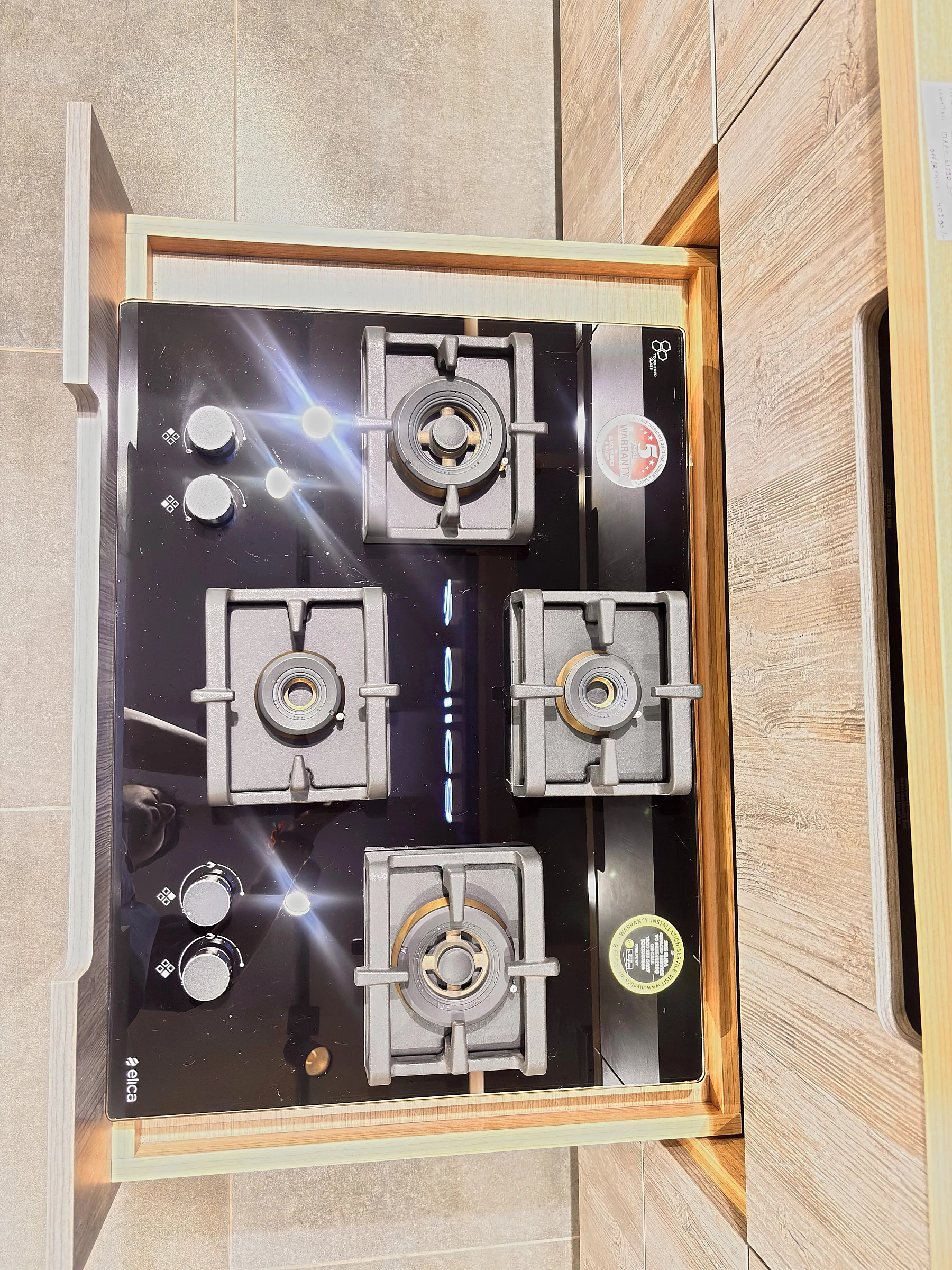 Elica built in gas hob with black glass top on a kitchen worktop