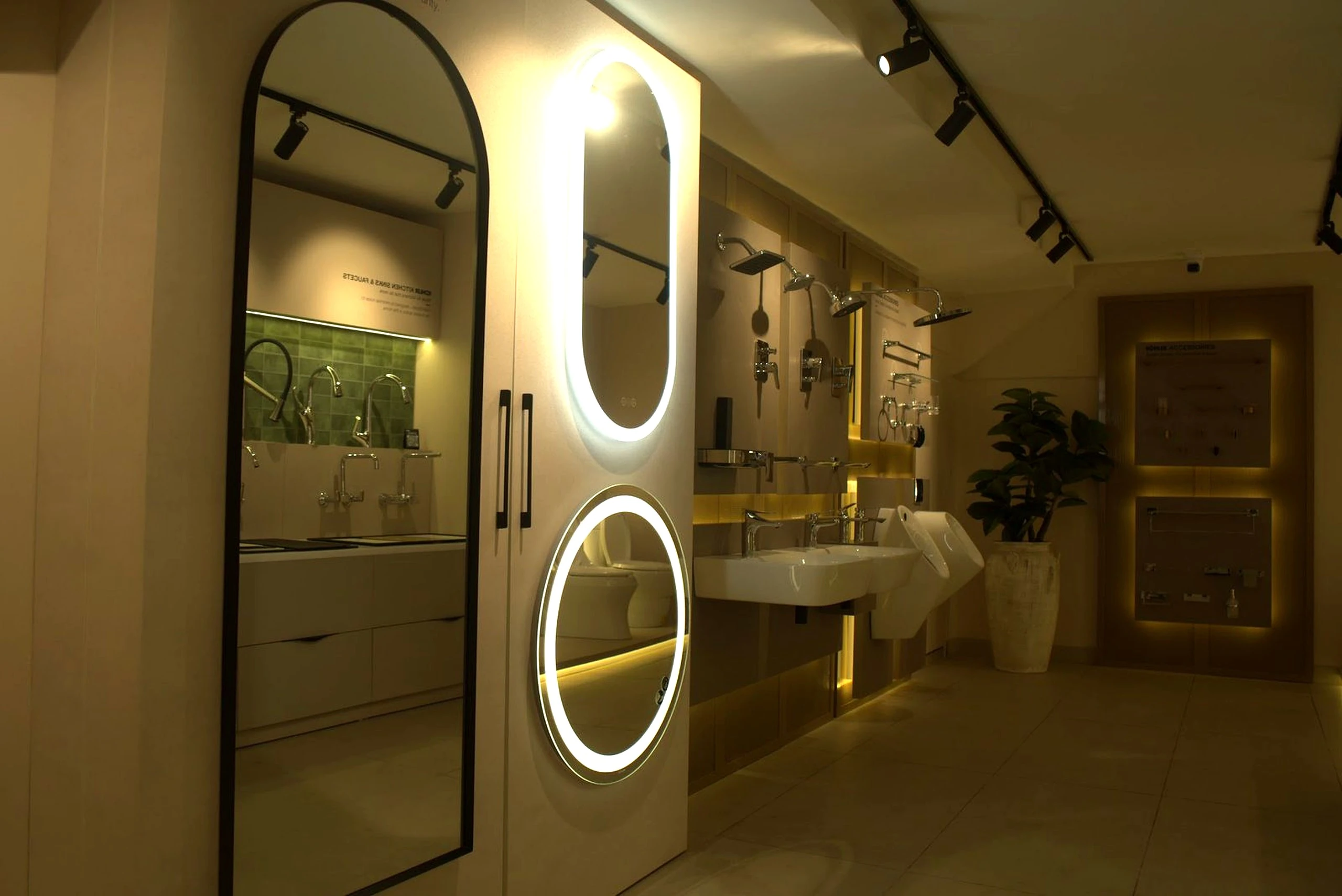 Green tiled feature wall behind a run of basins