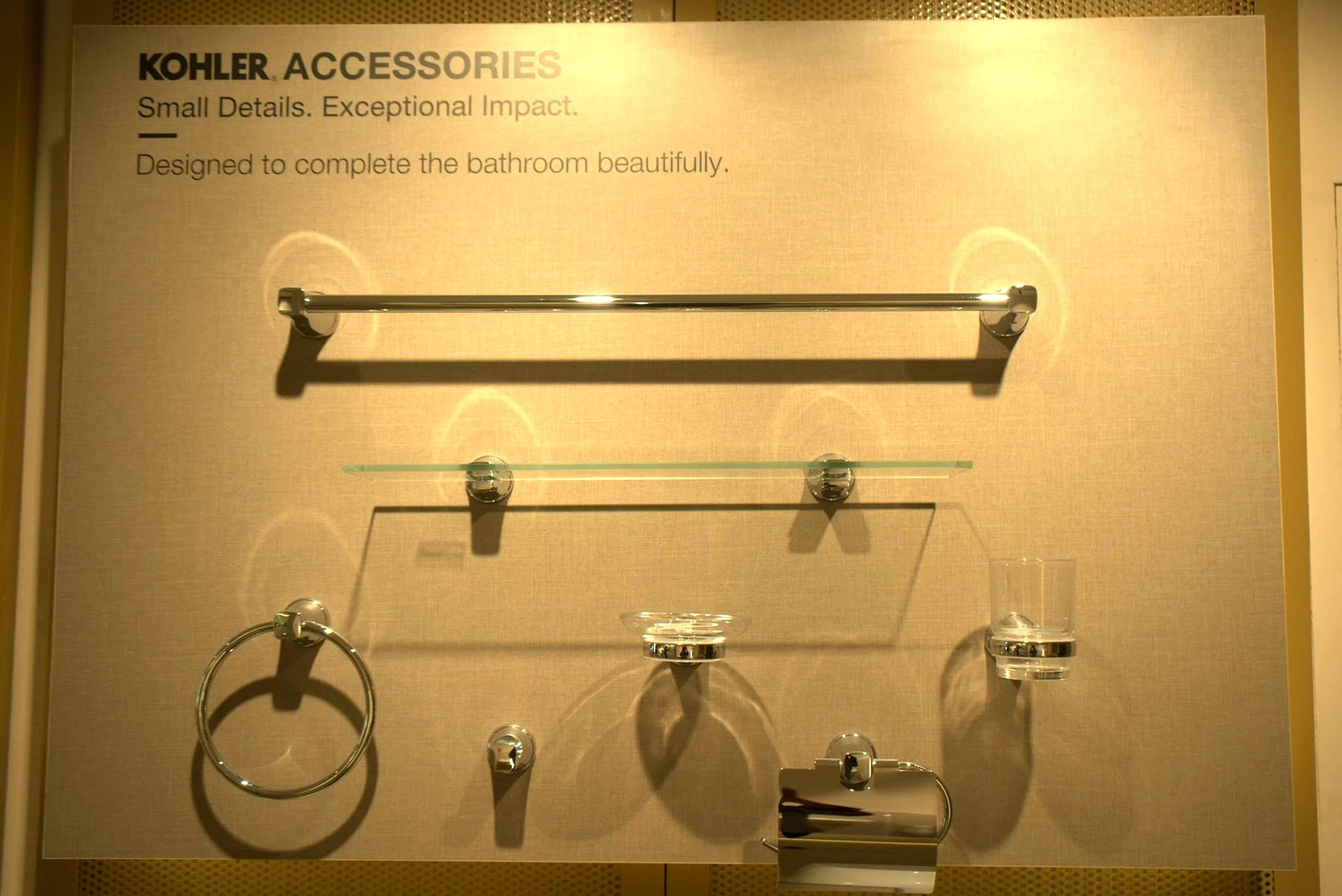 Bathroom accessories displayed on a lit panel